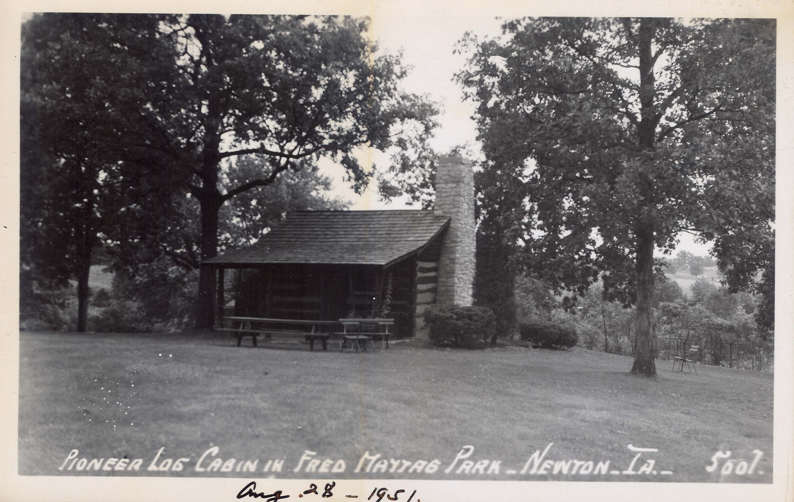 Post card image of a pioneer log cabin dating from 1848 in Jasper County, Iowa. The structure has been preserved in a park and is extant today