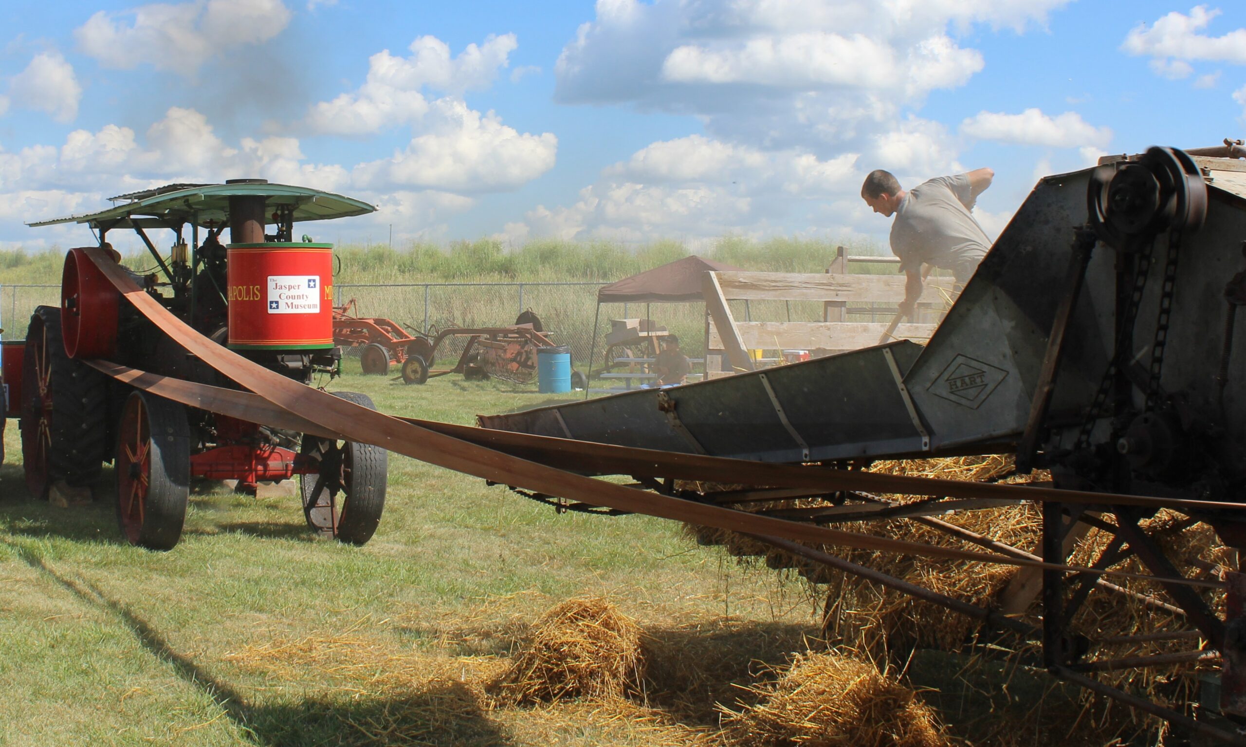A 100-year-old steam traction engine is belted up to a separator threshing oats. The old Minneapolis worked on a farm nearby to Owl Acres in the early and mid-20th century. Owned today by the Jasper County Historical Museum, it appears annually in parades and shows in central Iowa.